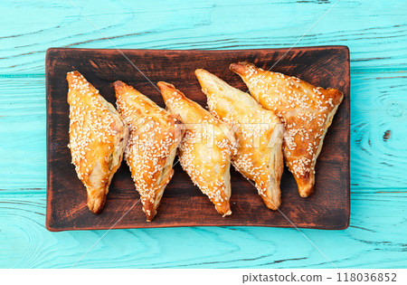 Homemade triangle puff pastry with meat on rustic background . Samosa Homemade triangle puff pastry with meat on rustic background . Samosa 118036852