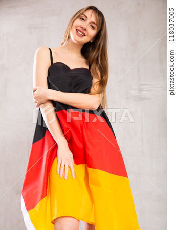 Young pretty woman proudly displaying flag of germany 118037005