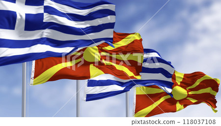 Flags of Greece and North Macedonia waving in the wind on a clear day Flags of Greece and North Macedonia waving in the wind on a clear day 118037108