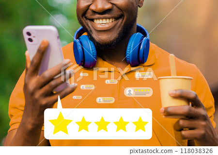 A man is holding a cell phone and smiling 118038326