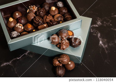 Box with a wide variety of chocolate bonbons. Box with a wide variety of chocolate bonbons. 118040054