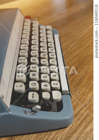 Retro old typewriter on blur background and front of wooden table. Vintage concept, selective Focus. Retro old typewriter on blur background and front of wooden table. Vintage concept, selective Focus. 118040518