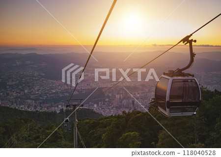 Modular cabins cable car against the bright sky, clouds ans mountains. Cableway - one of the popular urban rides in Caracas. toned image. Modular cabins cable car against the bright sky, clouds ans mountains. Cableway - one of the popular urban rides in Caracas. toned image. 118040528