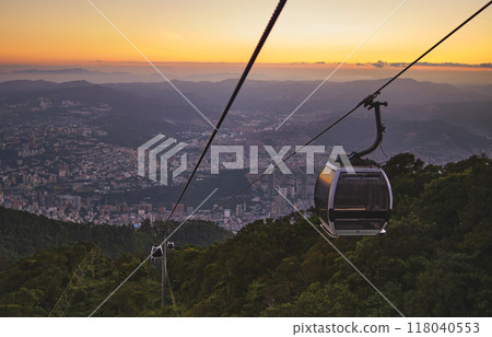 Modular cabins cable car against the bright sky, clouds ans mountains. Cableway - one of the popular urban rides in Caracas. toned image. 118040553