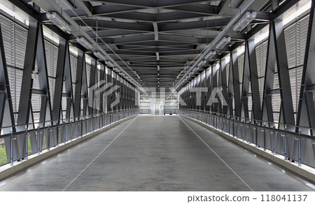 Pedestrian pathway or corridor or hallway between train station and other building. Pedestrian pathway or corridor or hallway between train station and other building. 118041137