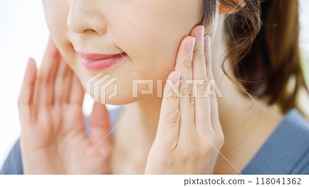 A woman with a face massage A woman with a face massage 118041362
