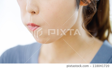 A woman using her tongue to massage away nasolabial folds 118041720