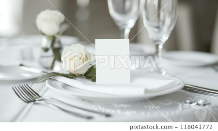 A beautifully arranged table featuring white roses and gleaming glassware, inviting guests to savor a delightful dining experience at a celebration A beautifully arranged table featuring white roses and gleaming glassware, inviting guests to savor a delightful dining experience at a celebration 118041772
