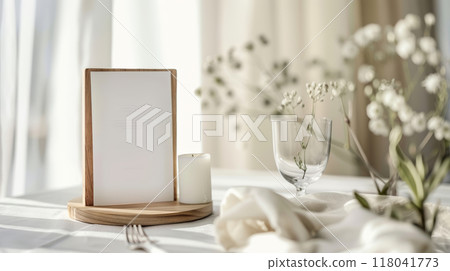 A beautifully arranged dining table features a wooden menu holder, fresh flowers, and a flickering candle, illuminated by gentle natural light for a warm ambiance A beautifully arranged dining table features a wooden menu holder, fresh flowers, and a flickering candle, illuminated by gentle natural light for a warm ambiance 118041773