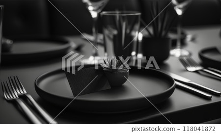 Dining table showcases a sleek black plate adorned with a small succulent centerpiece 118041872