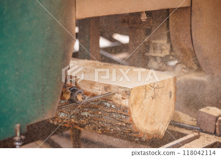 Close-Up of Band saw Cutting Log in Sawmill Close-Up of Band saw Cutting Log in Sawmill 118042114