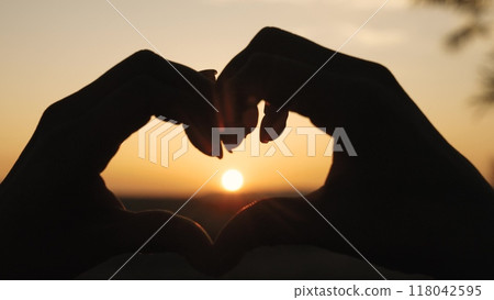 girl heart sign, sunset love symbol, hand silhouette heart, romantic gesture sunset, love hand silhouette, heart shape hands, fingers forming heart, romantic sign sunset, symbol of love sky, romantic 118042595