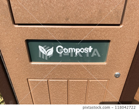 A public trash can with the word "compost" written on it 118042722