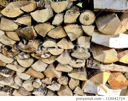 Firewood neatly stacked in a firewood shed 118042724