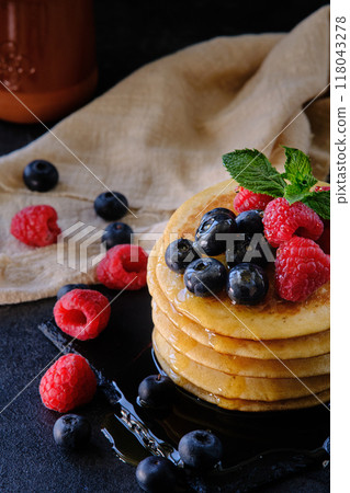 pancakes with berries and honey on dark background pancakes with berries and honey on dark background 118043278