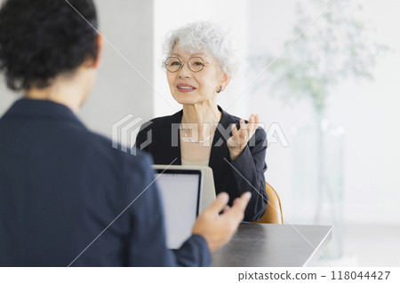 A senior woman operating a computer A senior woman operating a computer 118044427