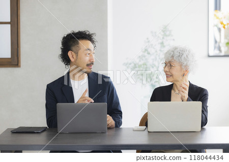 A senior woman operating a computer A senior woman operating a computer 118044434