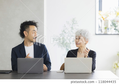 A senior woman operating a computer A senior woman operating a computer 118044435