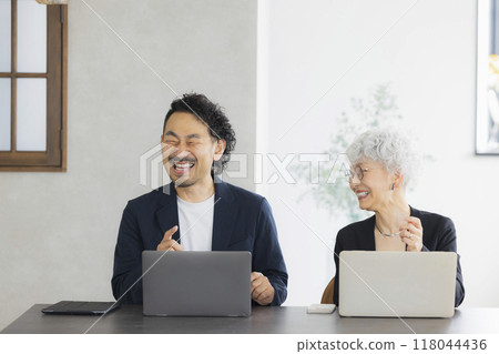A senior woman operating a computer A senior woman operating a computer 118044436