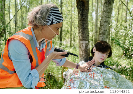 Checking pulse of unconscious camper Checking pulse of unconscious camper 118044831