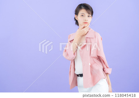 Young woman posing in jacket with purple back 118045418