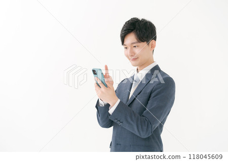 A businessman operating a smartphone A businessman operating a smartphone 118045609
