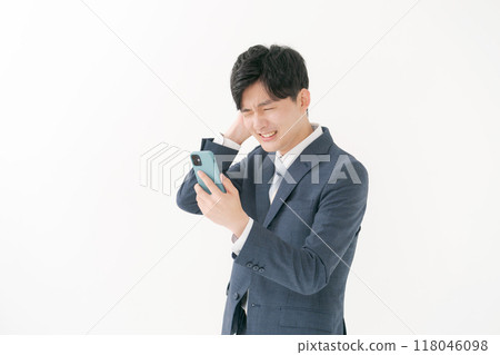 Business man worried about seeing a smartphone Business man worried about seeing a smartphone 118046098