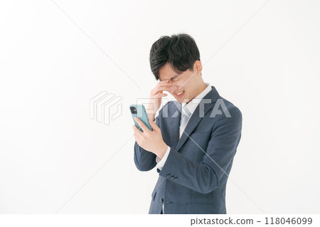 Business man worried about seeing a smartphone 118046099