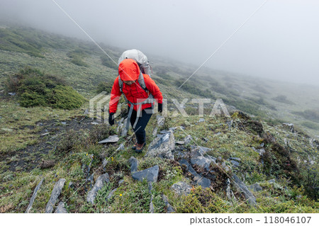 Hiking woman on high altitude mountain top Hiking woman on high altitude mountain top 118046107