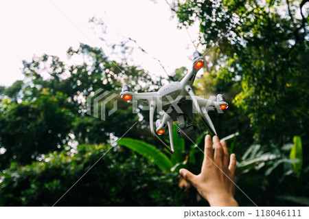 White drone with camera flying in summer mountains 118046111