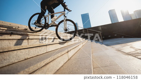 Woman free rider riding bike going down city stairs Woman free rider riding bike going down city stairs 118046158