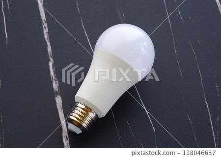 Image of an electricity bill with a light bulb on a black background 118046637