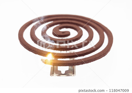 A mosquito coil with smoke coming out of it A mosquito coil with smoke coming out of it 118047009