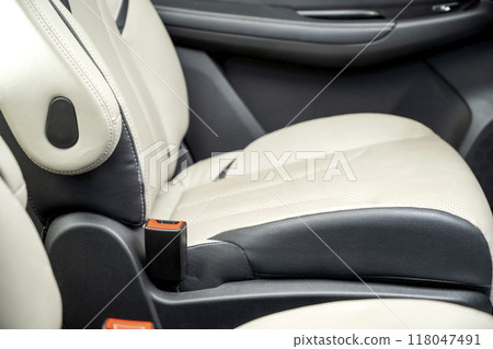 The back of a car seat is shown with a red button on the side The back of a car seat is shown with a red button on the side 118047491