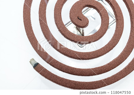 A mosquito coil with smoke coming out of it A mosquito coil with smoke coming out of it 118047550