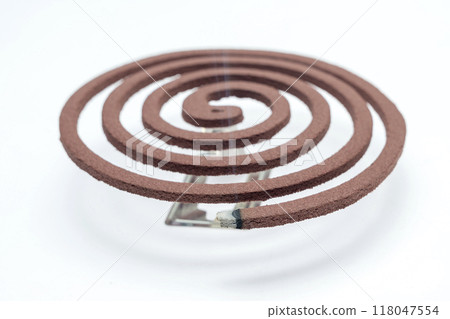 A mosquito coil with smoke coming out of it A mosquito coil with smoke coming out of it 118047554
