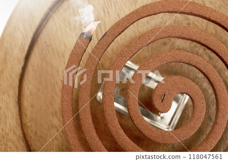 A mosquito coil with smoke coming out of it A mosquito coil with smoke coming out of it 118047561
