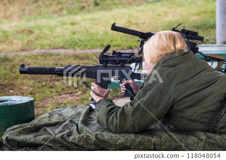 Man shooting at a target. Unformal shooting range Man shooting at a target. Unformal shooting range 118048054