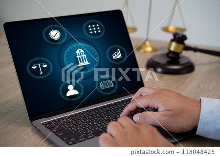 laptop computer with legal law scale Male judge working on laptop computer laptop computer with legal law scale Male judge working on laptop computer 118048425