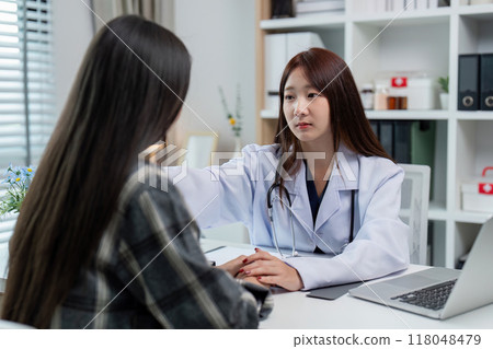 Doctor engaging with a patient in a health consultation Doctor engaging with a patient in a health consultation 118048479