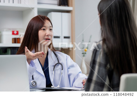 Medical consultation between female doctor and patient 118048492