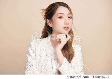 Beautiful young asian woman with clean fresh skin on beige background, Face care, Facial treatment, Cosmetology, beauty and spa, Asian women portrait. 118048727
