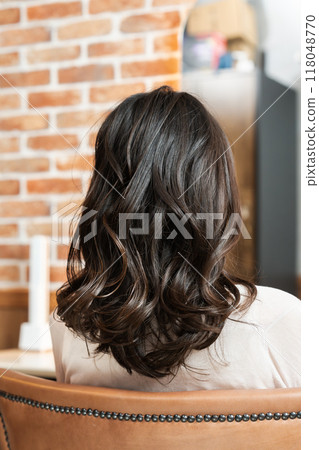 Woman with perm from behind Woman with perm from behind 118048770