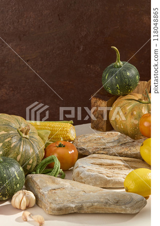 Advertising photo, autumn fruits just harvested. Pumpkins, lemons, tomato, corn, cowpea and garlic decorated with blocks of stone on vintage background. Vertical frame for advertising on social 118048865
