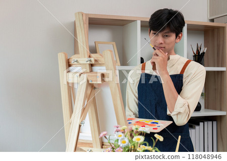Artist contemplating ideas for artwork at home Artist contemplating ideas for artwork at home 118048946