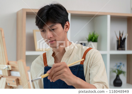 Artist concentrating on creating artwork at home Artist concentrating on creating artwork at home 118048949