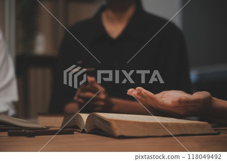 Christian group are praying to god with the bible and sharing the gospel. Concept of faith for god. 118049492