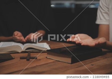 Christian group are praying to god with the bible and sharing the gospel. Concept of faith for god. 118049493