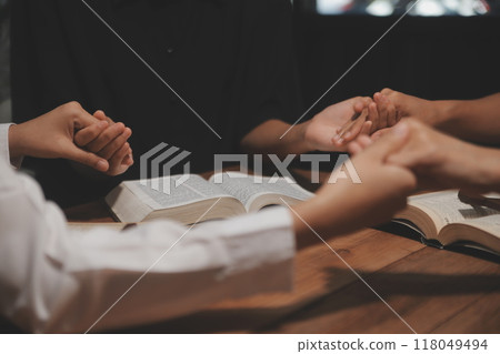Christian group are praying to god with the bible and sharing the gospel. Concept of faith for god. 118049494