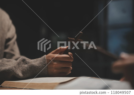 Christian group are praying to god with the bible and sharing the gospel. Concept of faith for god. 118049507